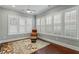Bright sun room with wood floors, ceiling fan, and many windows with plantation shutters at 201 Hales Wood Rd, Chapel Hill, NC 27517