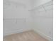 Spacious walk-in closet with carpeted floors and multiple wire rack shelves for optimal storage and organization at 201 Hales Wood Rd, Chapel Hill, NC 27517