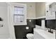 Clean bathroom with black and white tile, shower and natural light at 2401 Englewood Ave, Durham, NC 27705