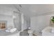 All-white bathroom featuring a shower, toilet, sink, and shower with glass doors at 2401 Englewood Ave, Durham, NC 27705