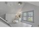 Bathroom with bright lighting, white cabinets, and large windows at 2401 Englewood Ave, Durham, NC 27705