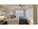 Comfortable bedroom featuring wood floors, ample natural light, and a ceiling fan at 2401 Englewood Ave, Durham, NC 27705
