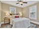 Comfortable bedroom featuring hardwood floors, two windows, and neutral decor at 2401 Englewood Ave, Durham, NC 27705