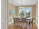 Bright dining room with large windows, chandelier, and wood floors, perfect for gatherings and Gathering meals at 2401 Englewood Ave, Durham, NC 27705