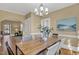 Inviting dining room showcasing modern chandelier, hardwood floors, and access to other rooms at 2401 Englewood Ave, Durham, NC 27705