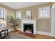 Beautiful fireplace with white mantle, black tile accents, and natural light from nearby windows at 2401 Englewood Ave, Durham, NC 27705