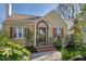 Charming home with a well-manicured lawn, brick entrance and colorful shutters at 2401 Englewood Ave, Durham, NC 27705