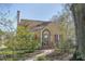 Charming two-story yellow home featuring red shutters and a brick-accented front entrance at 2401 Englewood Ave, Durham, NC 27705