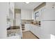 Bright kitchen features white cabinets, granite countertops and a window for natural light at 2401 Englewood Ave, Durham, NC 27705