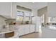 Efficient kitchen with white cabinets, granite countertops, and natural light, providing a clean and functional space at 2401 Englewood Ave, Durham, NC 27705