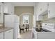 Bright kitchen featuring white appliances, modern countertops, and ample storage space at 2401 Englewood Ave, Durham, NC 27705