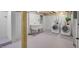 Basement laundry featuring a utility sink and modern washer and dryer set on a painted floor at 2401 Englewood Ave, Durham, NC 27705