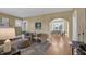 Spacious living room featuring hardwood floors, neutral walls, and an arched doorway to the dining room at 2401 Englewood Ave, Durham, NC 27705