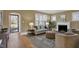 Bright and spacious living room with fireplace, comfortable seating, and hardwood floors at 2401 Englewood Ave, Durham, NC 27705