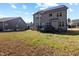 A spacious backyard featuring a multi-story home with solar panels and an outdoor deck, providing ample space at 253 Bendemeer Ln, Rolesville, NC 27571
