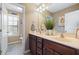 Bathroom featuring a double vanity, mirrors, and a view into the toilet room at 253 Bendemeer Ln, Rolesville, NC 27571