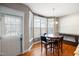Sunlit breakfast nook with a round table, wood floors, and a view of the outdoors at 253 Bendemeer Ln, Rolesville, NC 27571