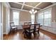 Elegant dining room featuring coffered ceilings, hardwood floors, and natural light at 253 Bendemeer Ln, Rolesville, NC 27571