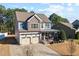 Charming two-story home featuring stone accents, a covered porch, and a two-car garage at 253 Bendemeer Ln, Rolesville, NC 27571