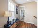 Hallway with wooden floors, a window with blinds, and decorative art at 253 Bendemeer Ln, Rolesville, NC 27571