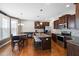 Kitchen featuring granite countertops, stainless steel appliances, and dark brown cabinets at 253 Bendemeer Ln, Rolesville, NC 27571