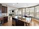 Kitchen island and breakfast nook with modern lighting and stainless steel appliances at 253 Bendemeer Ln, Rolesville, NC 27571
