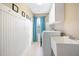 Bright laundry room features white cabinetry, a utility sink, and a washer and dryer hookup at 253 Bendemeer Ln, Rolesville, NC 27571