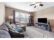 Relaxing living room offers comfortable seating, a ceiling fan and a large window for ample natural light at 253 Bendemeer Ln, Rolesville, NC 27571