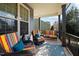 Cozy front porch with colorful striped seating and a decorative outdoor rug at 253 Bendemeer Ln, Rolesville, NC 27571