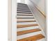 A beautiful staircase features wood treads and handrail, with white risers, offering a timeless and elegant design at 253 Bendemeer Ln, Rolesville, NC 27571