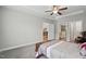 Bright, open bedroom leading to a bathroom and kitchen, featuring hardwood floors at 255 Thornwhistle Pl, Garner, NC 27529