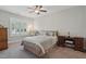 Cozy bedroom featuring carpeted floors, a neutral color scheme, plantation shutters, and a well made queen sized bed at 255 Thornwhistle Pl, Garner, NC 27529
