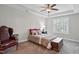 Serene bedroom with a plush bed, tray ceilings, and shuttered windows for privacy at 255 Thornwhistle Pl, Garner, NC 27529