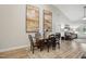 Inviting dining area with hardwood floors, high ceilings, and access to the living room at 255 Thornwhistle Pl, Garner, NC 27529