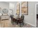 Elegant dining area with a wood table, stylish rug, and decorative wall art at 255 Thornwhistle Pl, Garner, NC 27529