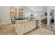 Open-concept kitchen with a large island, granite countertops, and stainless steel appliances at 255 Thornwhistle Pl, Garner, NC 27529