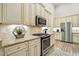 Bright kitchen with stainless steel appliances, granite countertops, and modern fixtures at 255 Thornwhistle Pl, Garner, NC 27529