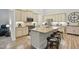 Kitchen featuring a large island with seating, stainless steel appliances, and ample cabinet space at 255 Thornwhistle Pl, Garner, NC 27529