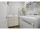Functional laundry room with a sink, storage cabinets, and a washing machine at 255 Thornwhistle Pl, Garner, NC 27529