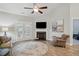 Another view of the living room with a fireplace and French doors leading to the outside at 255 Thornwhistle Pl, Garner, NC 27529
