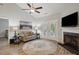 Cozy living room with a fireplace, hardwood floors, and a charming round rug at 255 Thornwhistle Pl, Garner, NC 27529