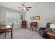 This office space features neutral colored walls, carpeted floors, with a desk, chairs, and a ceiling fan at 255 Thornwhistle Pl, Garner, NC 27529