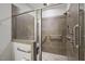 Close-up view of the tiled walk-in shower with glass doors and a built-in shower bench at 255 Thornwhistle Pl, Garner, NC 27529