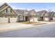 Street view of attached townhomes with 2 car garages, neutral paint, and well manicured lawns at 255 Thornwhistle Pl, Garner, NC 27529