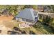 Drone shot of the property featuring a fire pit, outdoor seating, and well-maintained lawn at 260 Crestdale Dr, Clayton, NC 27520