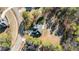 Aerial view of a house with a patio and firepit nestled in a wooded neighborhood at 260 Crestdale Dr, Clayton, NC 27520