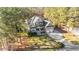 An aerial view of a beautiful home nestled among mature trees, showcasing its spacious lot and long driveway at 260 Crestdale Dr, Clayton, NC 27520