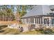 Outdoor entertainment area featuring a stone fire pit and grill on the backyard patio at 260 Crestdale Dr, Clayton, NC 27520