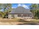 An expansive backyard featuring a stone fire pit, screened porch, and pristine landscaping at 260 Crestdale Dr, Clayton, NC 27520