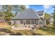 Beautiful backyard features a stone fire pit, screened porch, patio, grill and manicured landscaping at 260 Crestdale Dr, Clayton, NC 27520